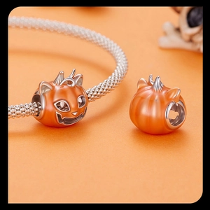 Detailed macro view of S925 sterling silver pumpkin cat charm on a chain bracelet