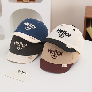 Breathable baby baseball cap with Hello smile embroidery in four colors on white table