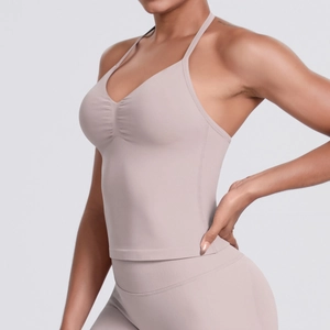 Detail shot of seamless nude yoga tank top showing fine ribbed texture and pleated chest design