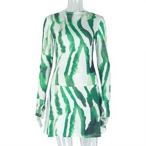 Detail of green ink-style long sleeve top and mini skirt set on a transparent mannequin