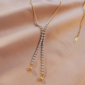 Luxurious Y-shaped gold-plated rhinestone necklace on silk background with K18 engraving