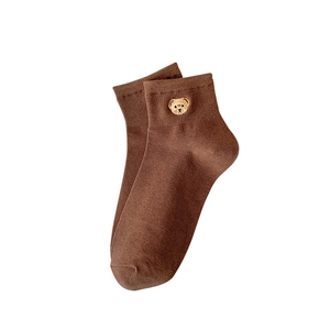 Brown low cut cotton blend socks featuring cute gold bear embroidery on white background