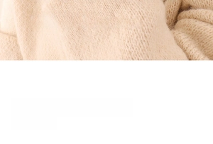 Detailed macro texture of soft cream-colored knitted fabric with fine ribbed patterns