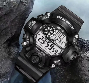 Detail of waterproof digital sports watch with triple sensor on wet rock background