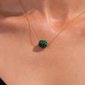 Lapis lazuli pendant necklace in gold-plated titanium steel worn on a model neckline