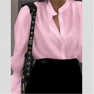 Detail of pink ruffled blouse showing lantern sleeves and white button-up closure