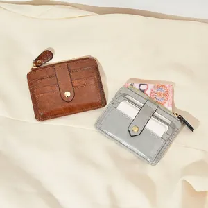 Minimalist leather card holder with zipper pocket in brown and light grey blue colors