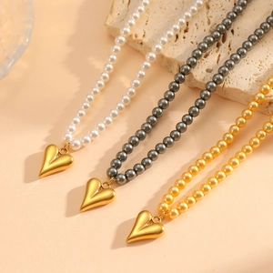 Elegant pearl heart necklaces set in white, grey, and gold with polished metal heart charms