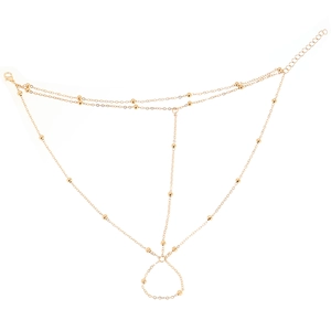 Macro shot of 18K gold bead hand chain with adjustable lobster clasp and fine link design
