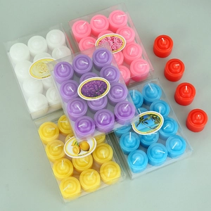 Close-up of assorted colorful scented tea light candles in transparent gift boxes