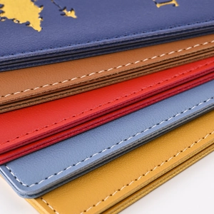 Close-up of PU leather passport covers in blue, brown, red, and yellow with neat stitching