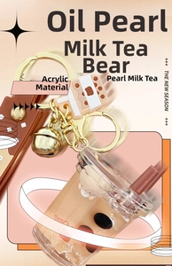 Detailed macro view of bubble tea keychain with floating bear and liquid quicksand effects