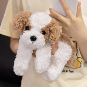 Cute plush puppy toy with white and brown soft fur held in hands for size reference