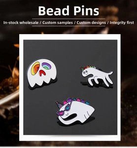 Detailed close-up of cartoon unicorn and ghost enamel pins with vibrant colorful drip oil craft