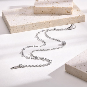 Detail of stainless steel chain bracelet with lobster clasp and round clear zircon stone