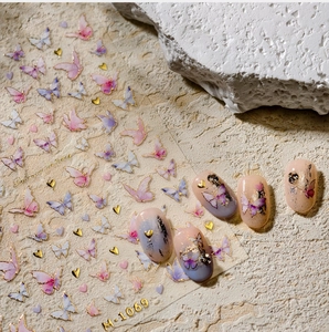 Macro shot of 3D butterfly nail art stickers M-1069 with gold hearts and pink details
