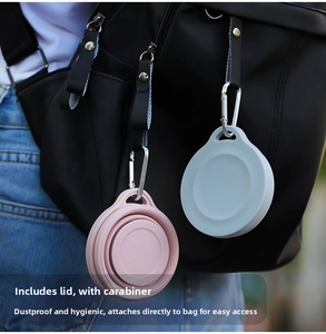 Collapsible silicone travel cup with carabiner attached to a backpack strap