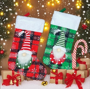Christmas stockings with faceless Santa gnomes on rustic wood with festive decor