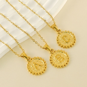 Close-up of 18k gold plated stainless steel necklaces with A, B, C letter pendants
