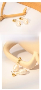 Macro detail of French vintage baroque pearl earrings with 18k gold plated finish