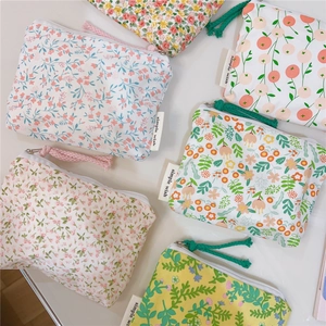 Close-up of floral cotton coin purses with simple wish labels and zipper details