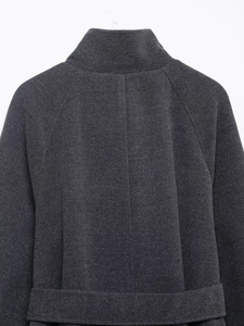 Detailed view of the dark grey stand-collar coat showing premium twill fabric texture
