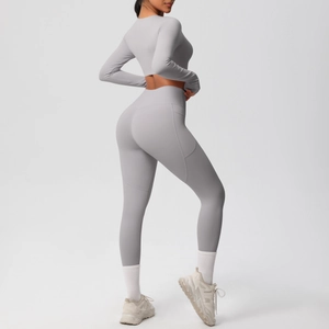Detail view of high-waist light grey yoga leggings featuring a functional side phone pocket