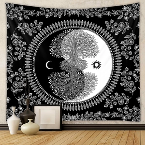 Detail of bohemian black and white tapestry featuring tree of life and mandala elements