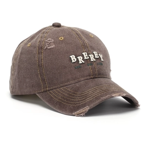Close-up of distressed vintage brown cotton baseball cap with white towel embroidery