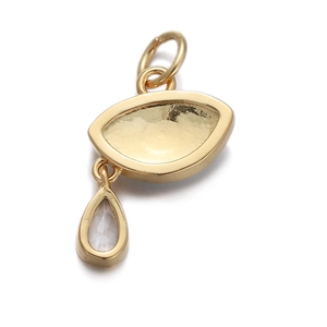 Detail of gold evil eye pendant featuring sparkling zircon drop and polished metal finish