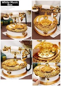 Detail view of vintage white telephone music box with rose reliefs and heart drawer
