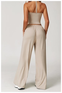 Back view of beige wide-leg pants and halter top showing smooth fabric drape and fit