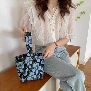 Vintage floral jacquard underarm bag with blue flower pattern and metal snap closure