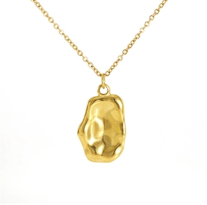 Detailed close-up of a gold-plated irregular lava texture pendant on a fine link chain