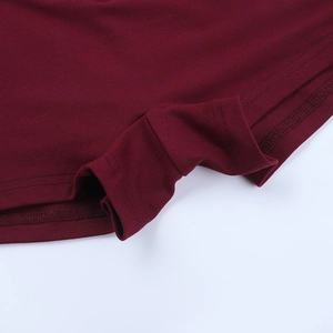 Detailed close-up of double-needle stitching on burgundy knitted fabric hem for women jumpsuit