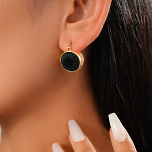 Detail of vintage gold textured hoop earring with black velvet and pearl center for women