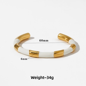 Detail view of gold and white enamel bamboo bracelet showing dimensions 60mm and 6mm
