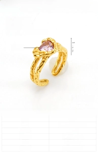 Macro shot of 18K gold plated heart pink zircon ring with irregular lava texture