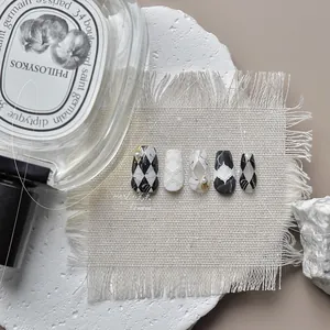 Detail of luxury marble texture press-on nails with 3D relief lines and pearl accents