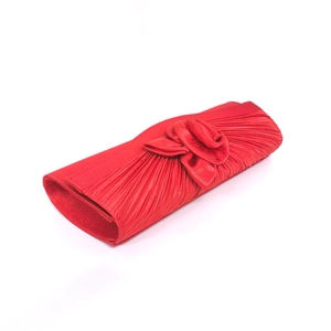 Detail of red satin pleated evening clutch bag with handcrafted 3D floral decoration