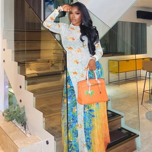 Chic long sleeve A-line dress with goldfish print and orange handbag in modern setting