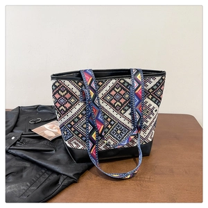Detail of ethnic geometric canvas tote bag with black leather base and jacquard strap