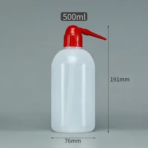 Detailed macro view of 500ml translucent plastic wash bottle with red curved precision nozzle