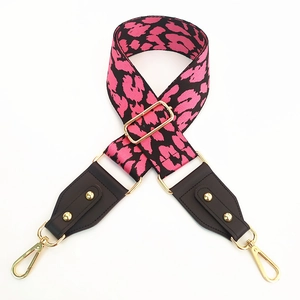 Detailed view of pink leopard print wide strap with gold hardware and leather ends
