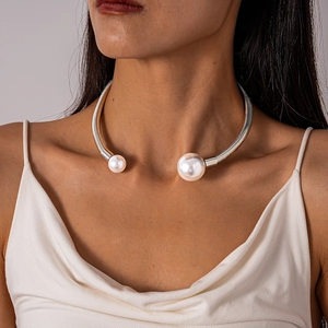 Detail of silver spring metal neck collar featuring two white pearls on model