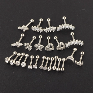 Detailed view of silver stainless steel cartilage earrings set with zircon moon and heart