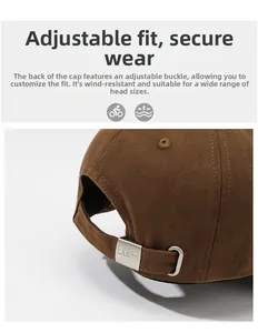 Detail of adjustable metal buckle with brand engraving on brown cotton baseball cap