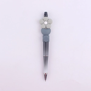 Detail of beaded pen with black and white gradient body and gray silicone daisy top