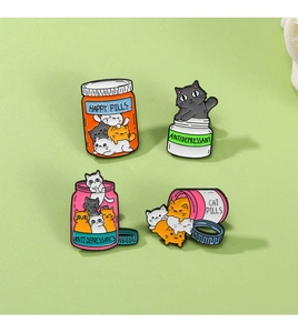 Macro shot of 4 colorful cat pill jar enamel pins showing sharp metallic lines and glossy finish