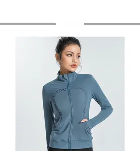 Detail of grey-blue yoga jacket featuring unique U-shaped ruffled trim and slim-fit zipper